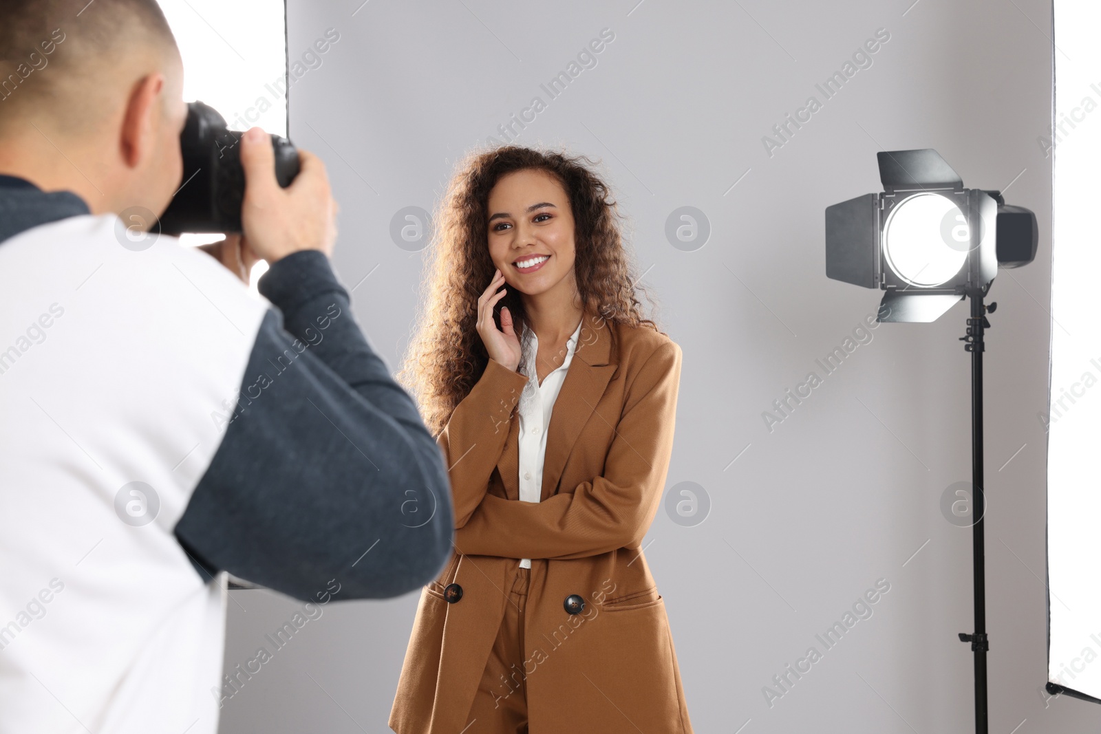 Photo of Beautiful African American model posing for professional photographer in studio