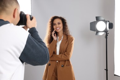 Beautiful African American model posing for professional photographer in studio