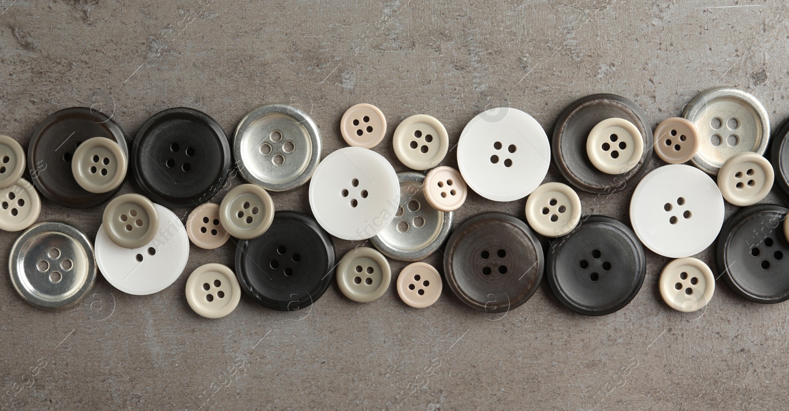 Photo of Many plastic sewing buttons on grey background, flat lay