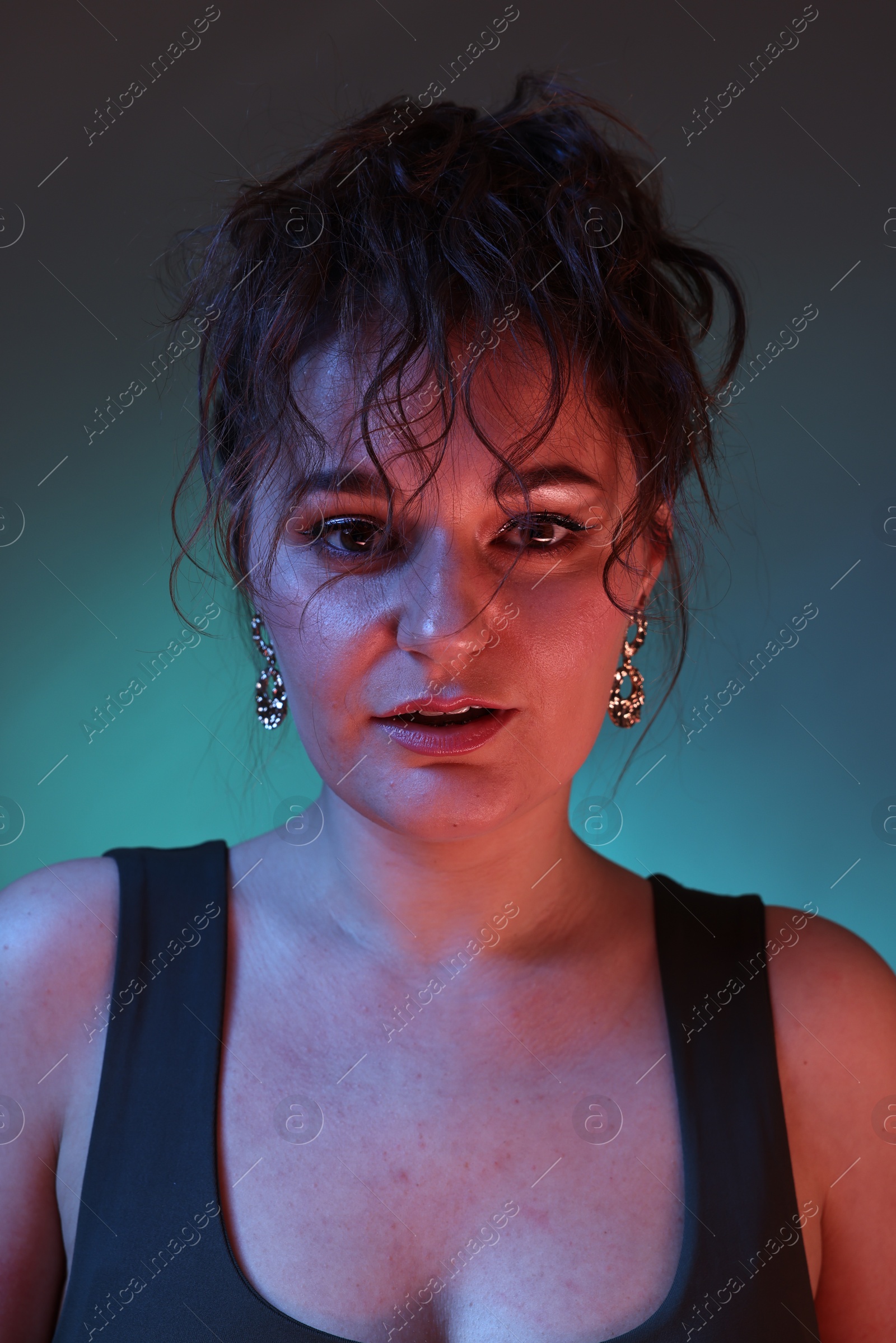 Photo of Portrait of beautiful woman on dark background with neon lights