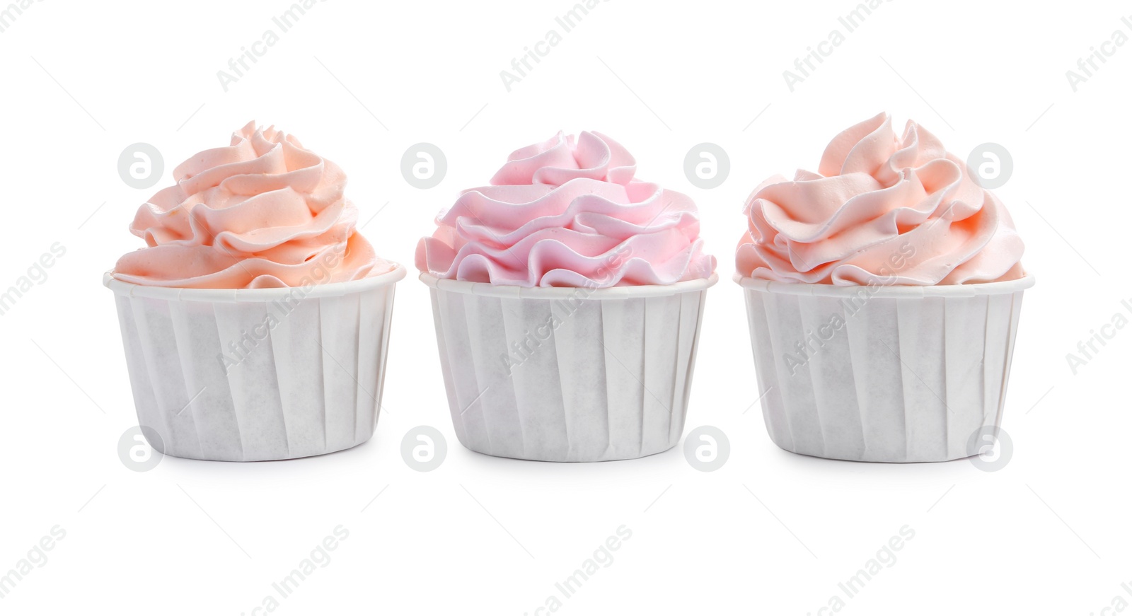 Photo of Tasty cupcakes with cream isolated on white