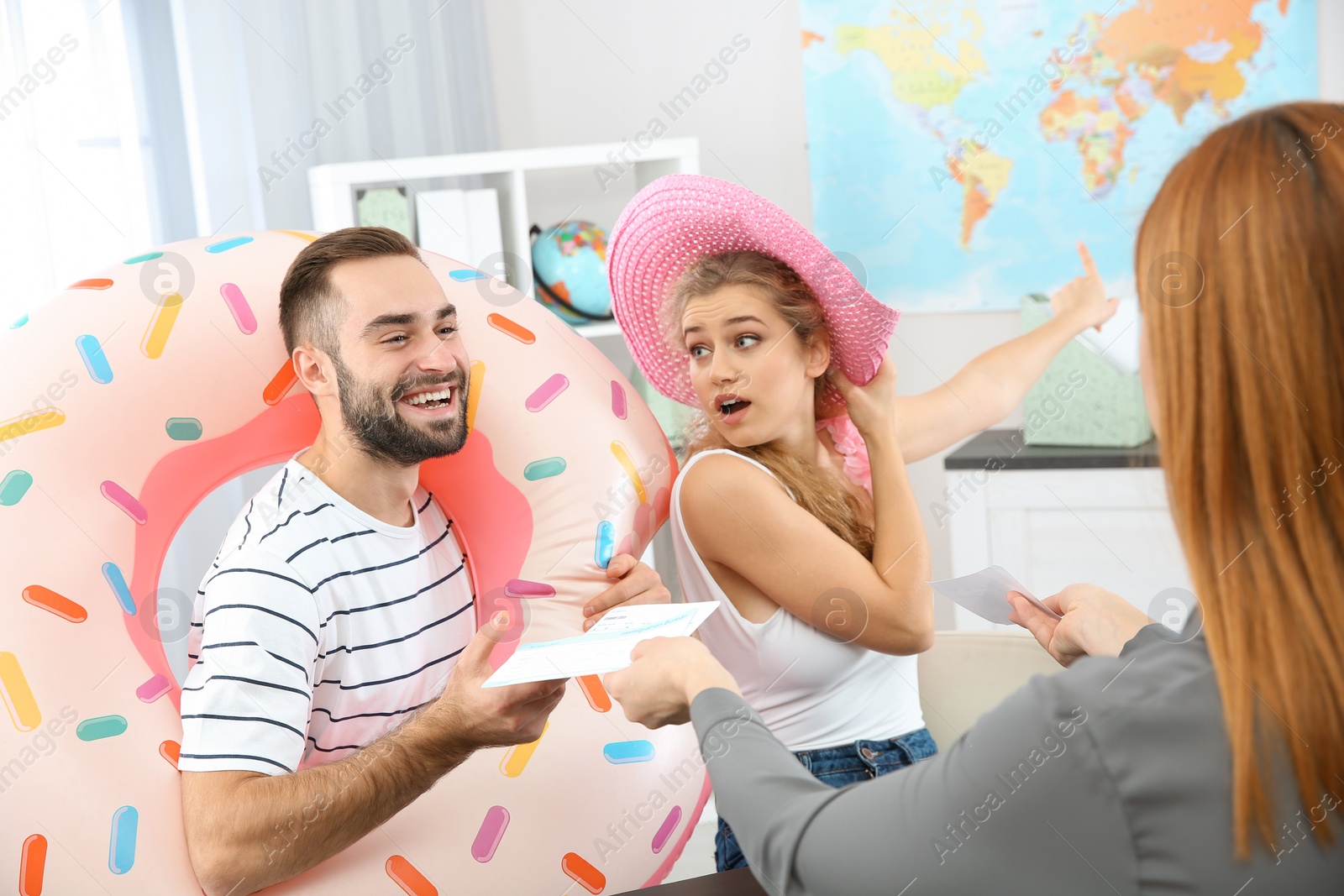 Photo of Beautiful young couple visiting travel agency office