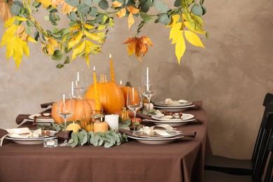 Photo of Beautiful autumn place setting and decor on table in room