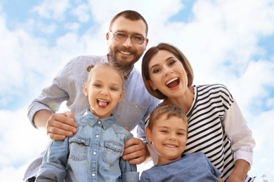 Happy family spending time together with their children outdoors