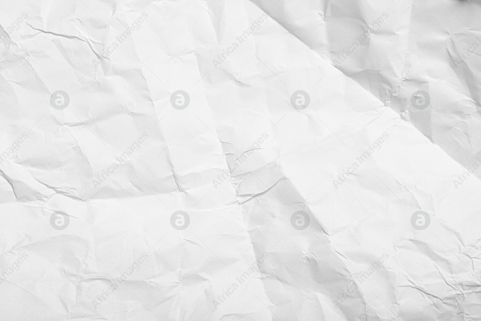 Photo of Sheet of white crumpled paper as background, closeup