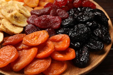 Different delicious dried fruits on table, closeup