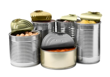 Open tin cans with different products on white background