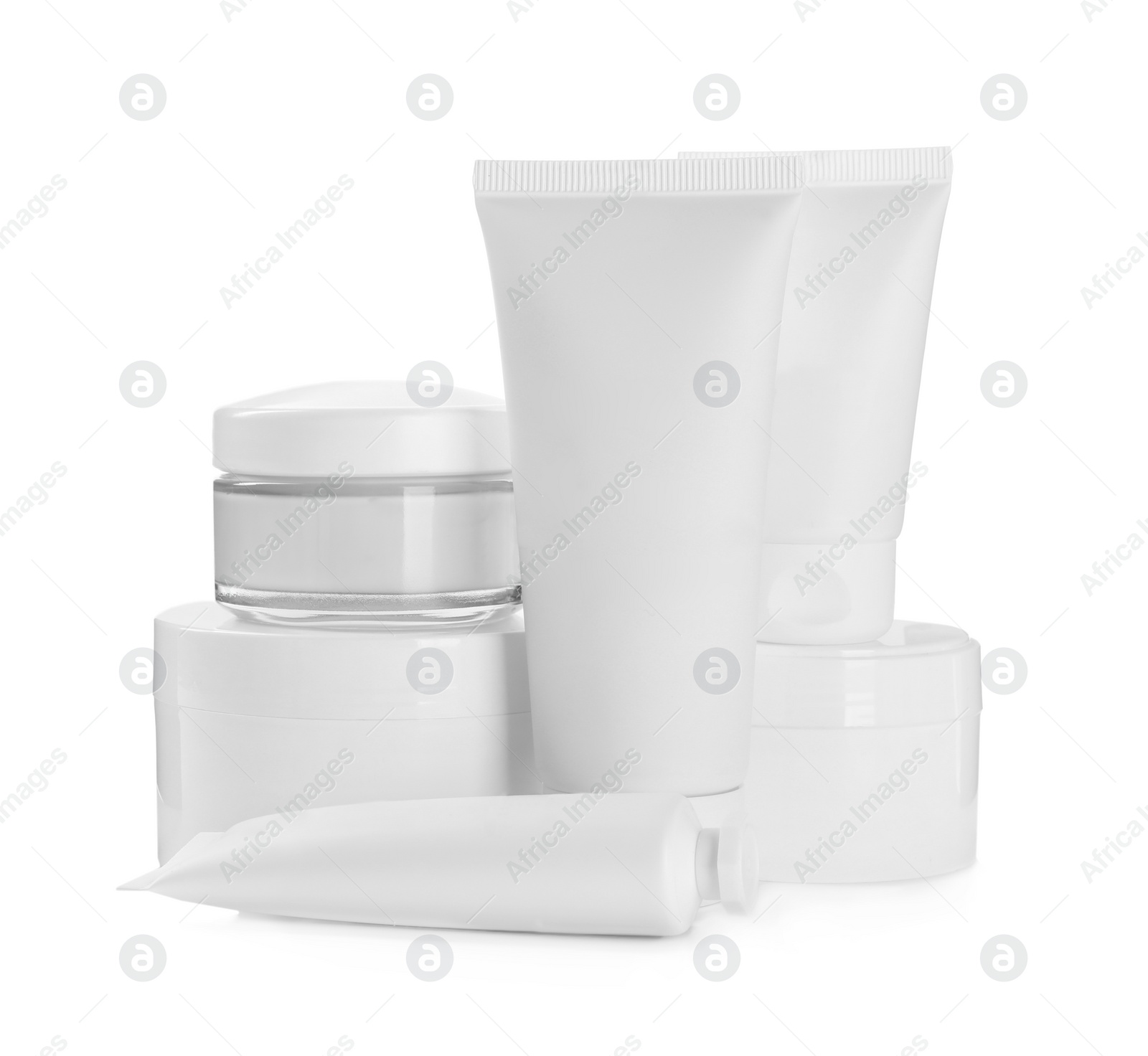 Photo of Blank tubes and jars of cosmetic products on white background