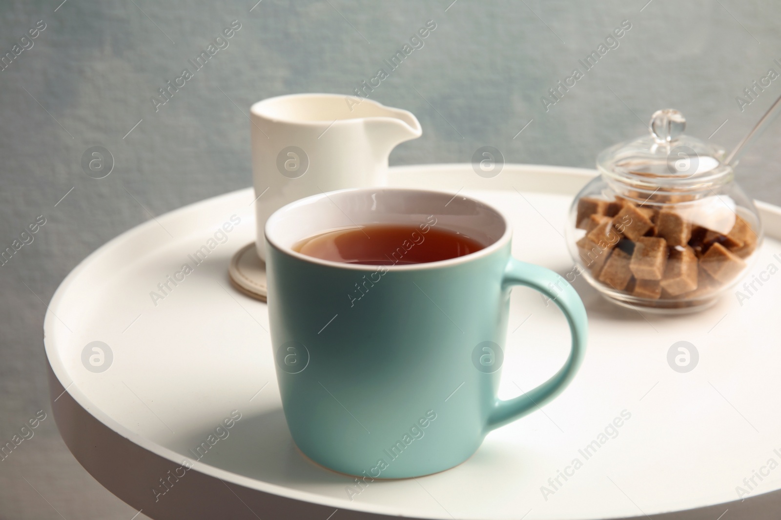 Photo of Cup of black tea on round table