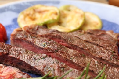 Photo of Delicious grilled beef steak with spices on plate, closeup