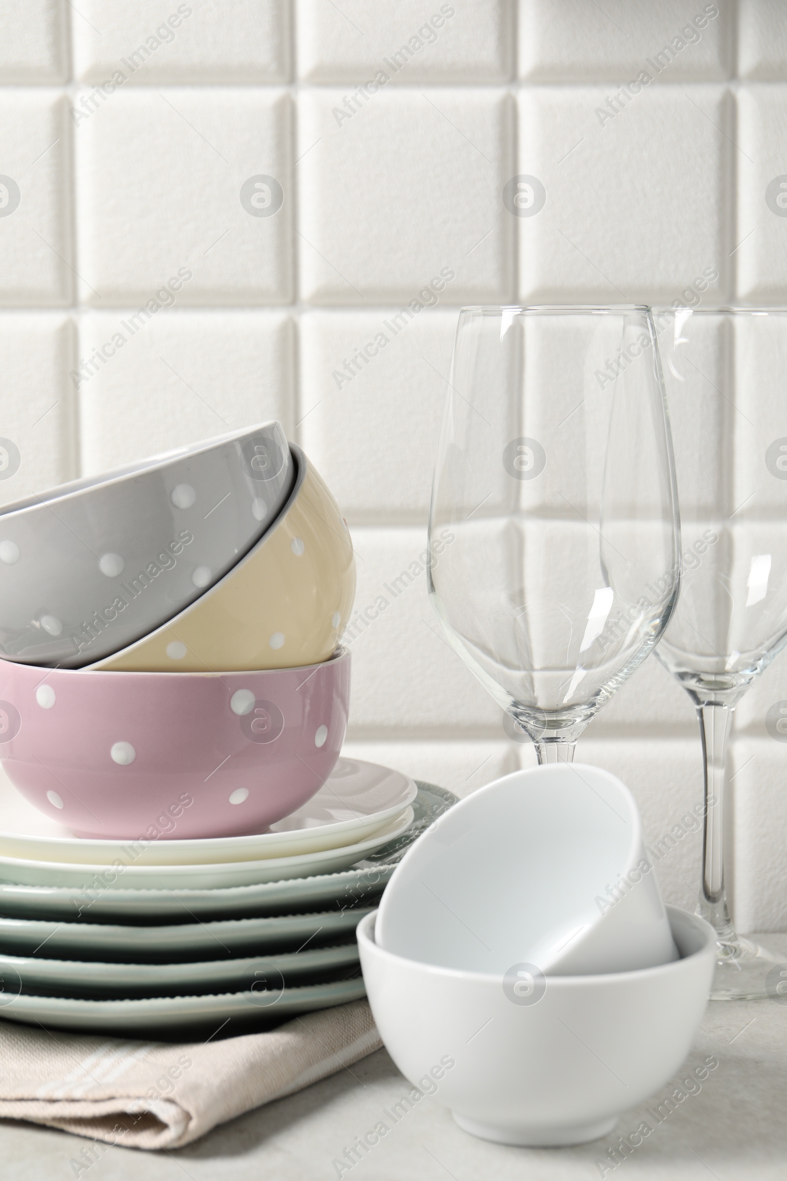 Photo of Beautiful ceramic dishware and glasses on light grey table