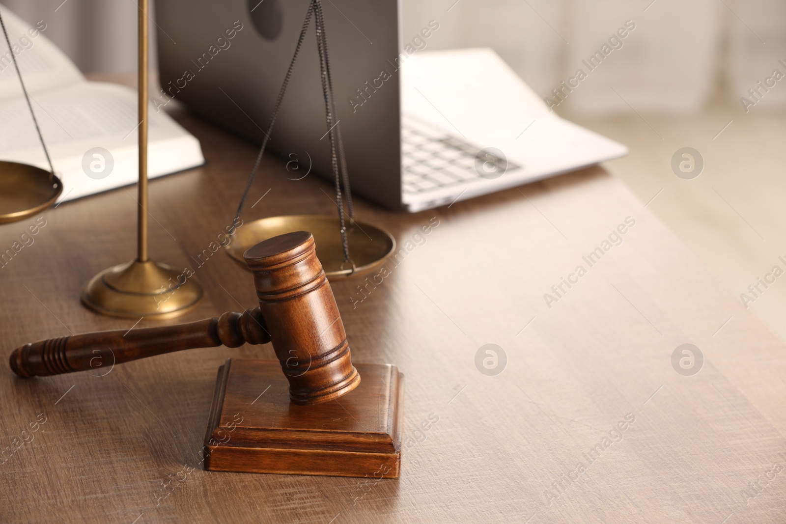 Photo of Law concept. Gavel, scales of justice and laptop on wooden table, space for text