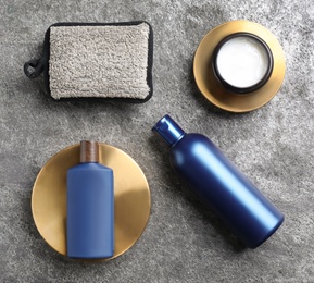 Flat lay composition with men's cosmetics on grey stone background