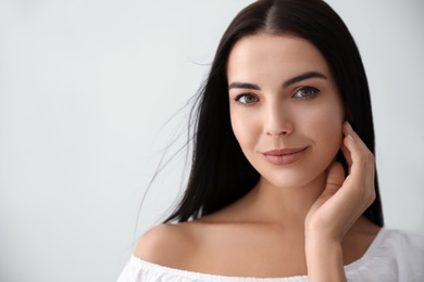 Photo of Beautiful young woman on light grey background