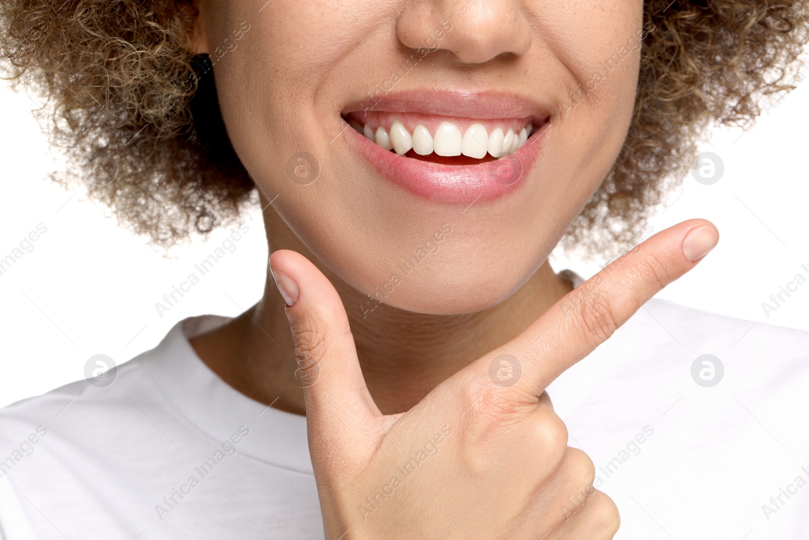 Photo of Woman showing her clean teeth and smiling on white background, closeup