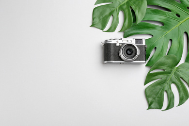 Flat lay composition with camera for professional photographer on light background, top view