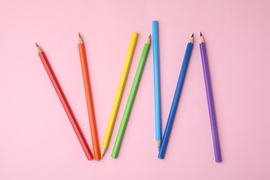 Photo of Colorful wooden pencils on pink background, flat lay