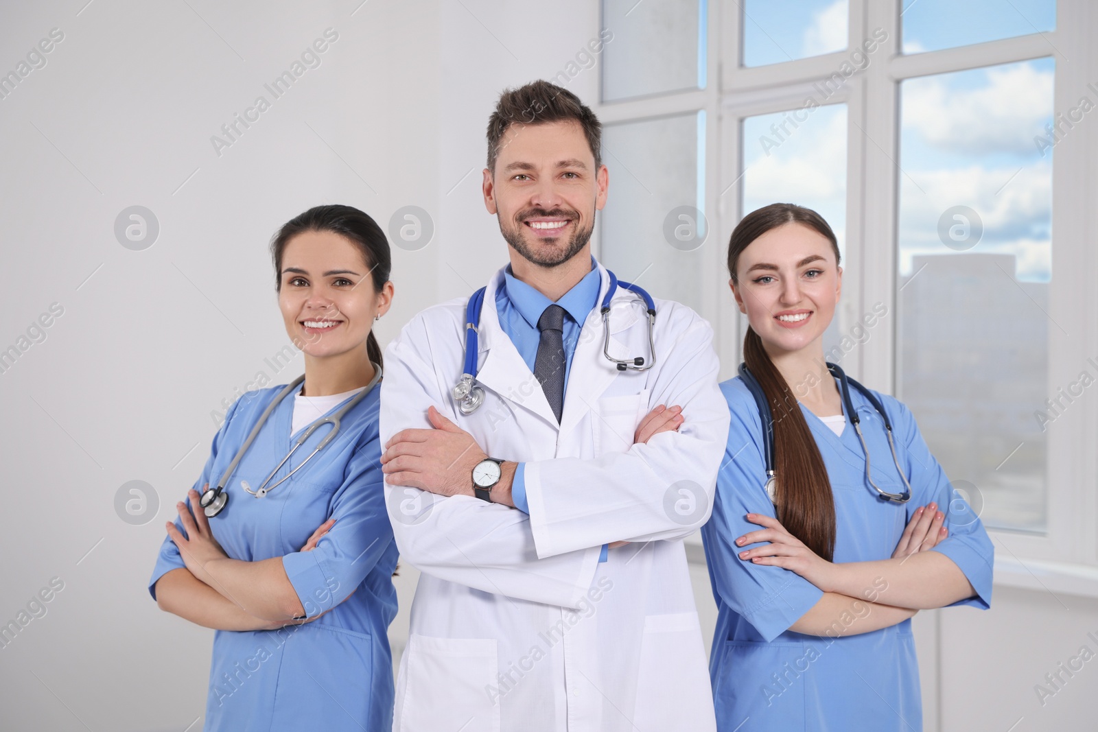 Photo of Team of professional doctors in clinic hallway