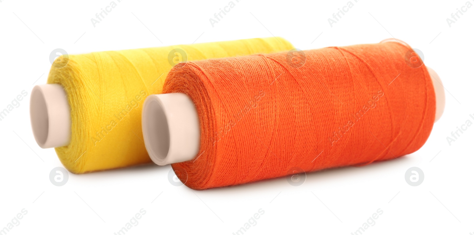 Photo of Different colorful sewing threads on white background, closeup