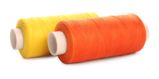 Different colorful sewing threads on white background, closeup