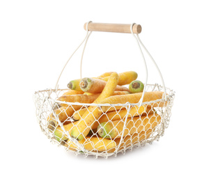 Photo of Raw yellow carrots in metal basket isolated on white