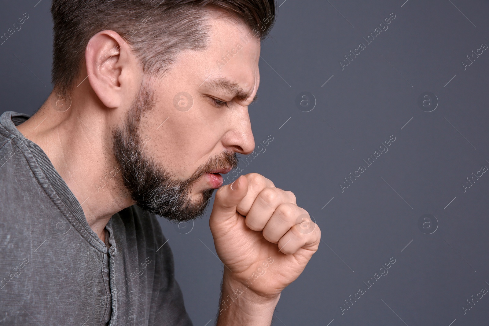 Photo of Mature man coughing on color background