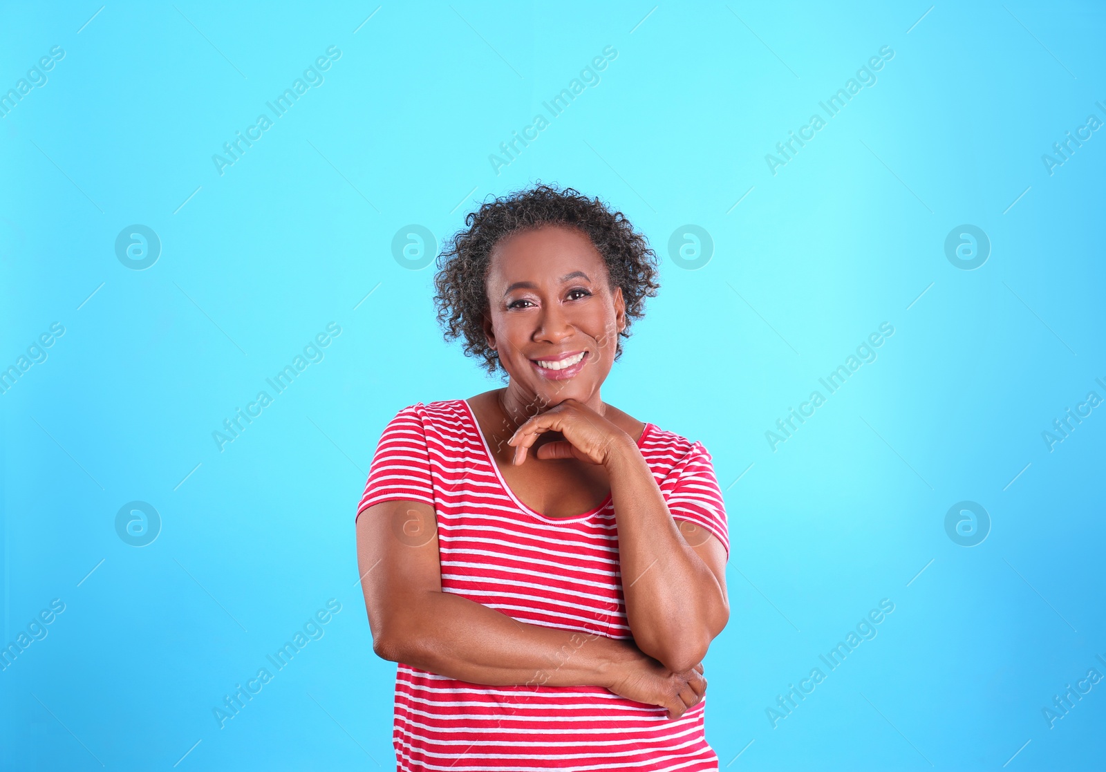 Photo of Portrait of happy African-American woman on light blue background