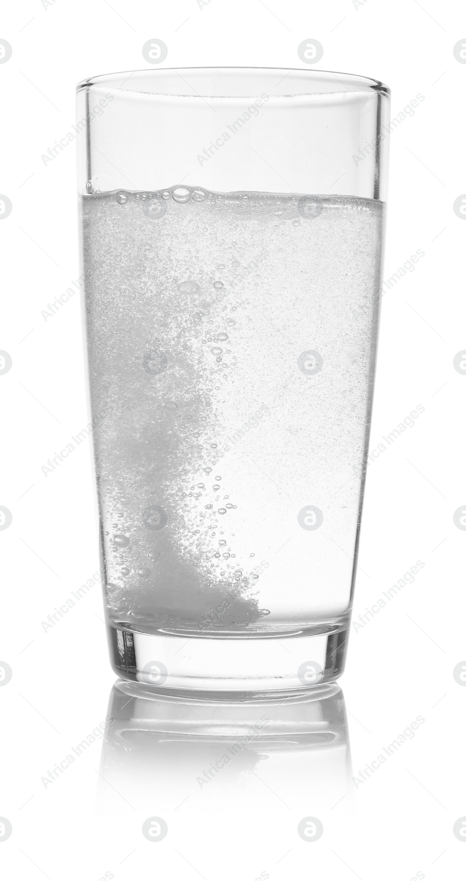 Photo of Effervescent pill dissolving in glass of water isolated on white