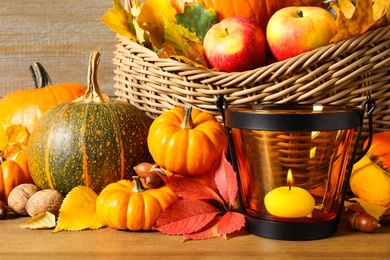 Composition with ripe pumpkins and autumn leaves on wooden table, closeup. Happy Thanksgiving day
