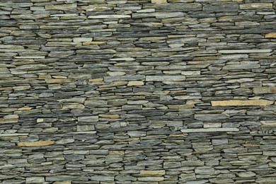 Photo of Texture of grey stone wall as background