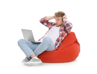 Emotional man with laptop on white background