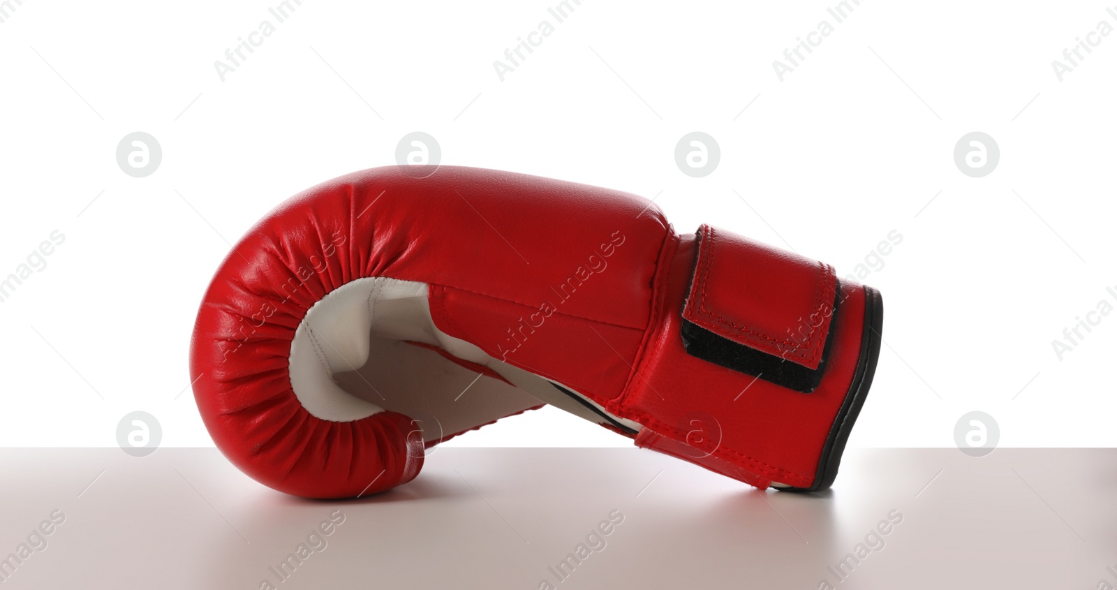 Photo of New red boxing glove isolated on white