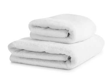 Photo of Folded clean soft towels on white background