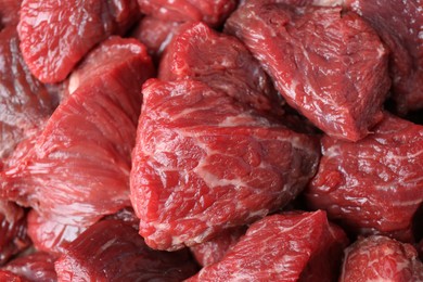 Pieces of raw beef meat as background, closeup