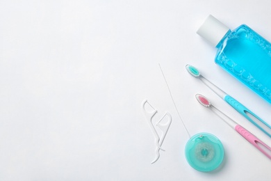 Photo of Flat lay composition with manual toothbrushes and oral hygiene products on white background