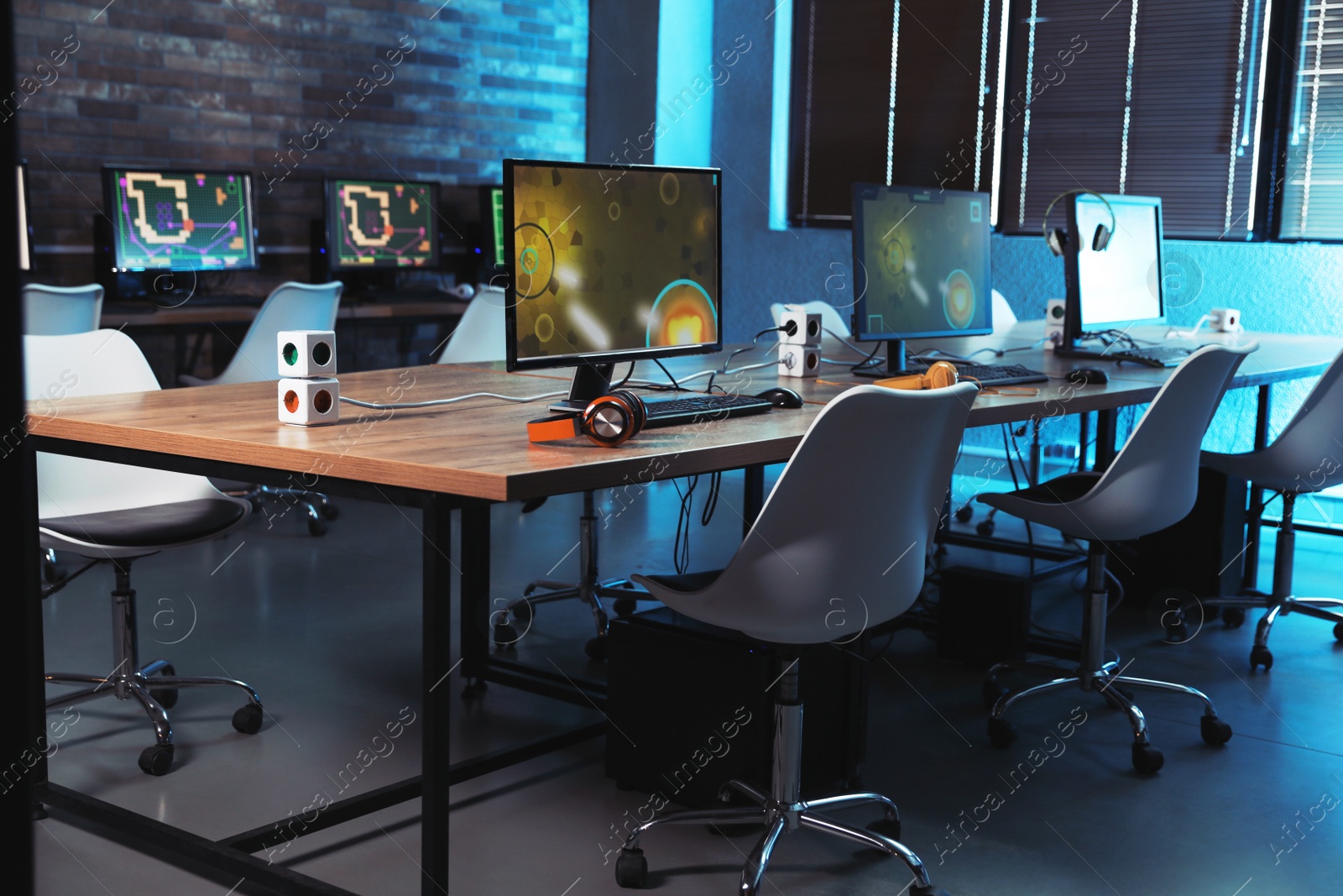 Photo of Internet cafe interior with modern computers. Video game tournament