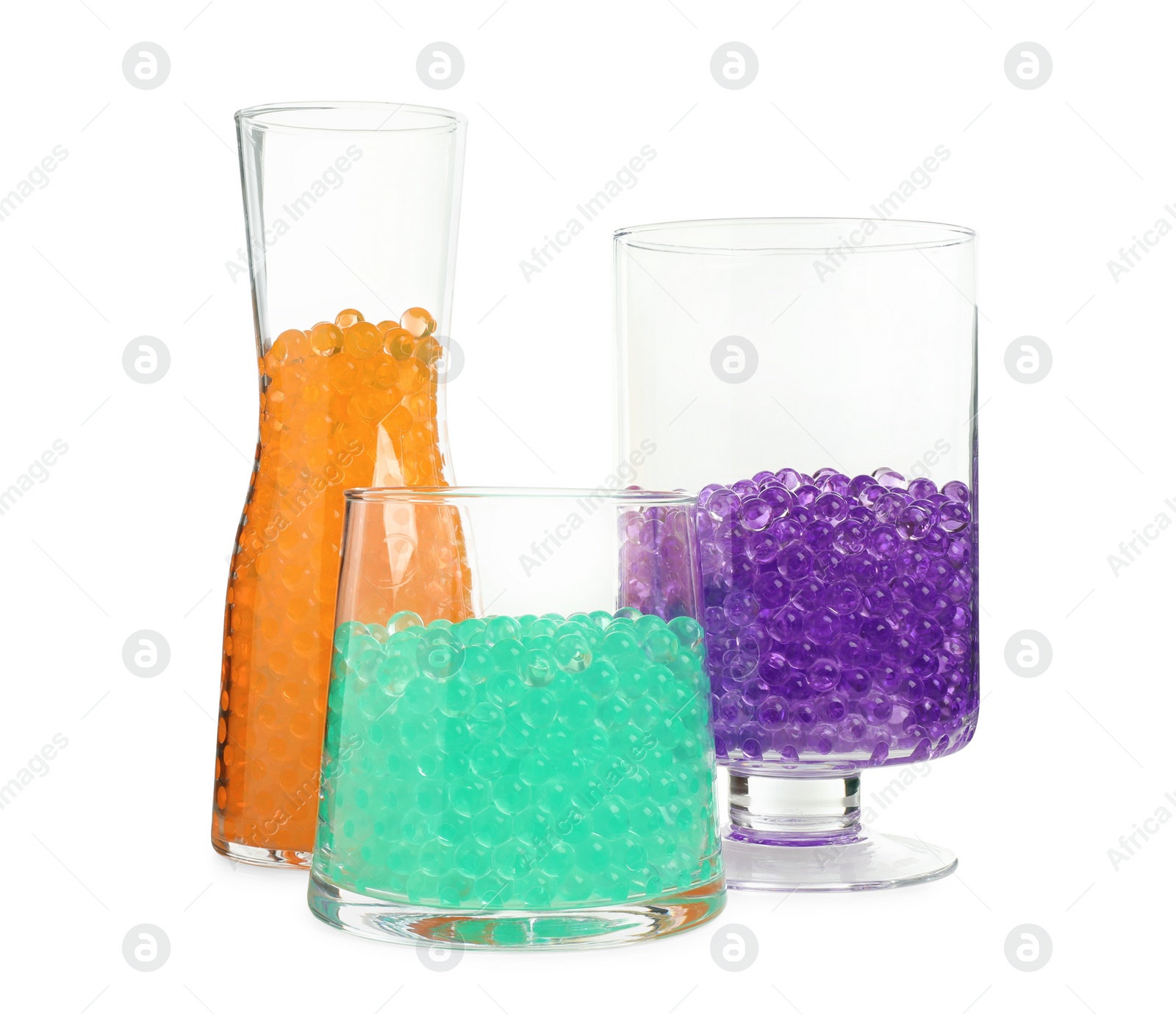 Photo of Different color fillers in glass vases isolated on white. Water beads