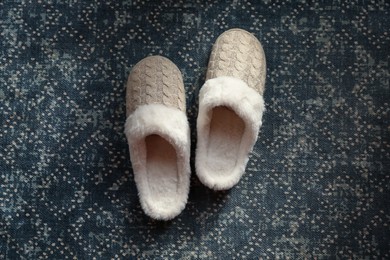 Pair of beautiful soft slippers on carpet, top view