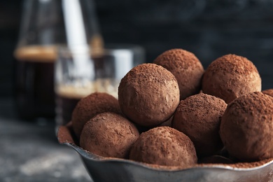 Bowl with tasty chocolate truffles, closeup view