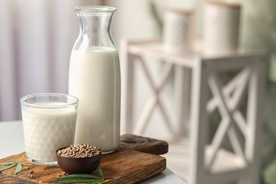 Composition with hemp milk on white table indoors