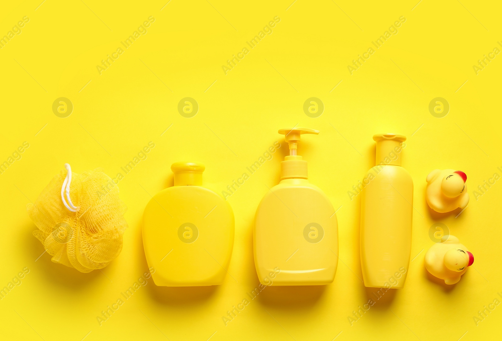 Photo of Flat lay composition with baby cosmetic products on yellow background