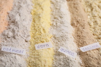 Photo of Different types of flours as background, closeup