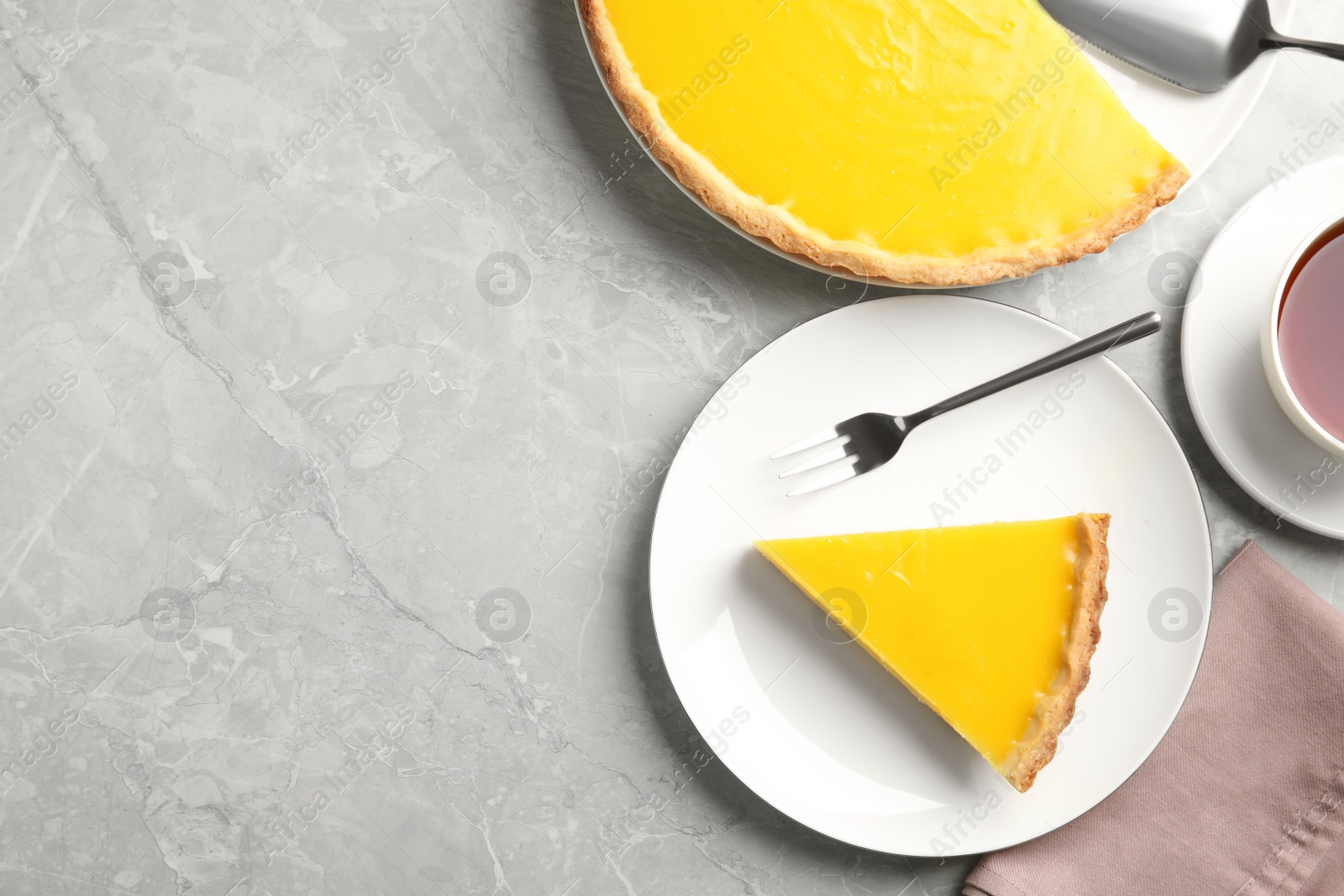 Photo of Delicious homemade lemon pie on light grey table, flat lay. Space for text