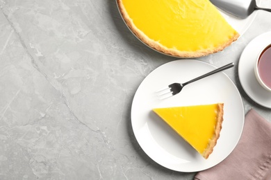 Photo of Delicious homemade lemon pie on light grey table, flat lay. Space for text