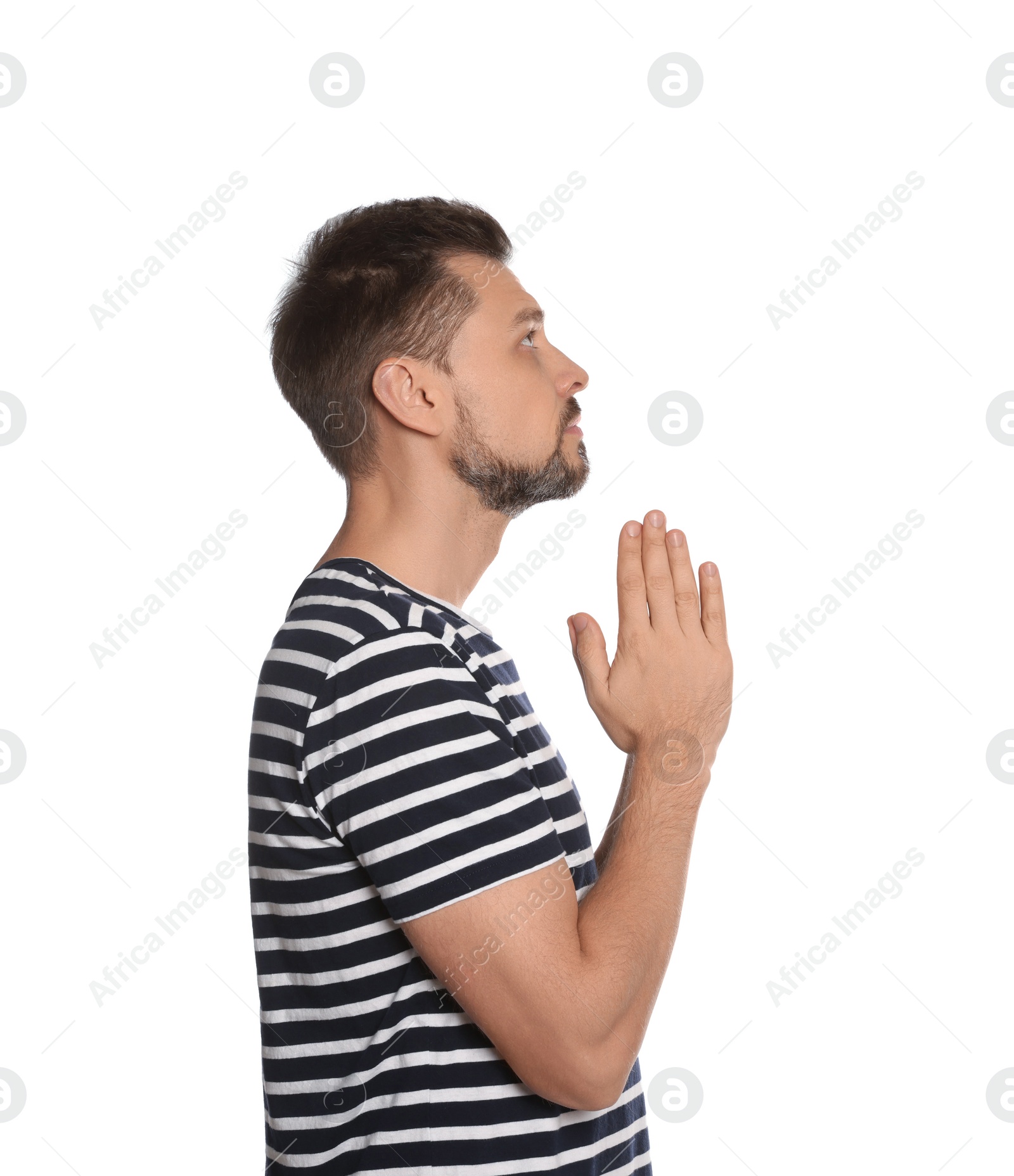 Photo of Man with clasped hands praying on white background