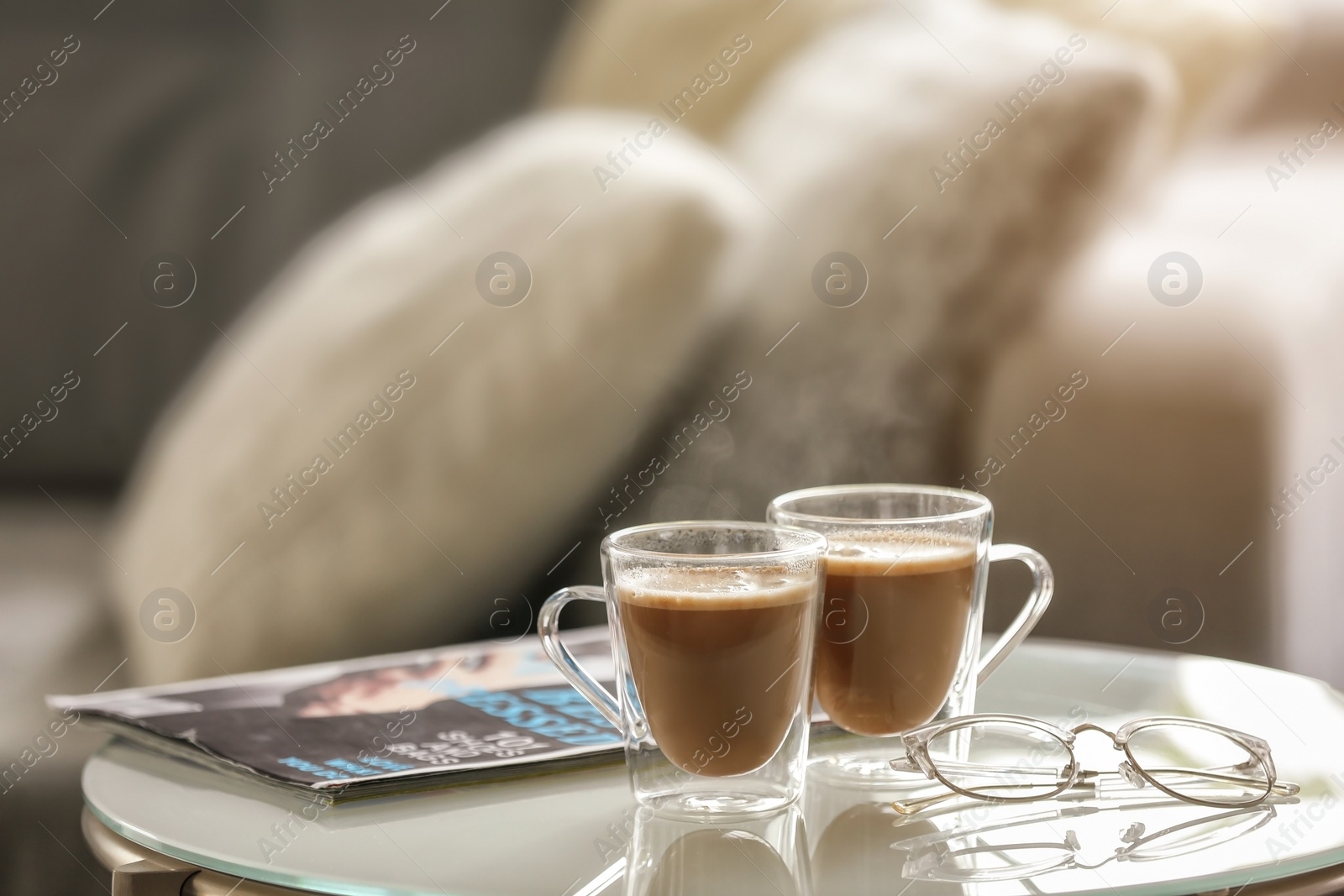 Photo of Cups of aromatic coffee on table