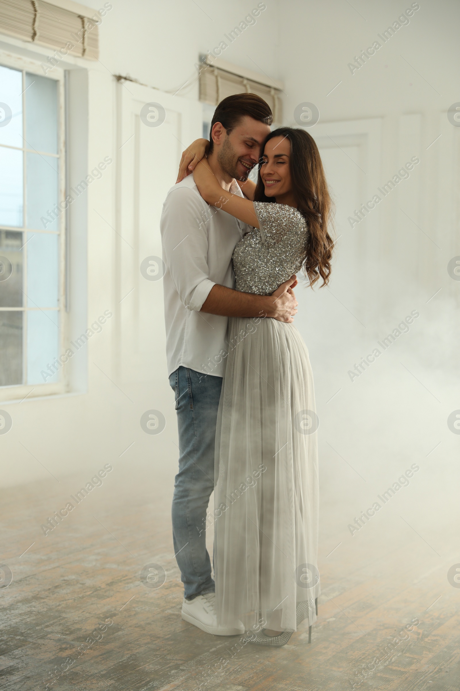 Photo of Lovely young couple dancing together in ballroom