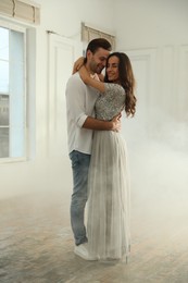 Photo of Lovely young couple dancing together in ballroom