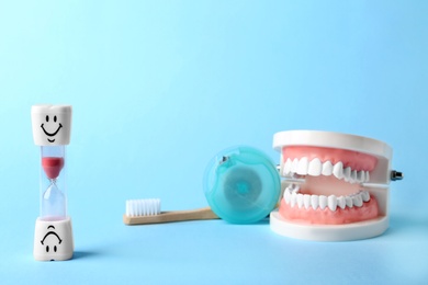 Composition with dental hourglass on color background, space for text. Healthy teeth