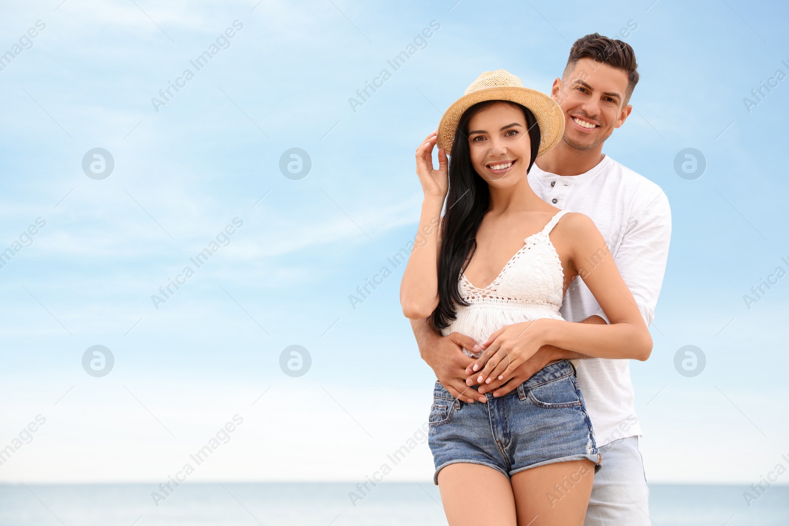 Photo of Lovely couple spending time together on beach. Space for text